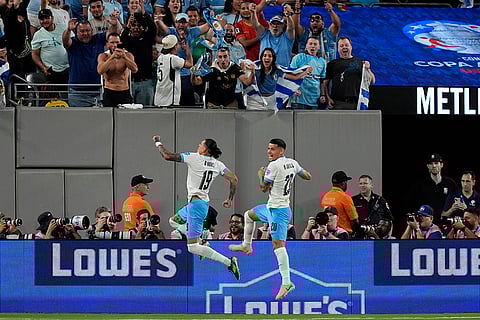 Darwin Nunez, left, celebrates after scoring Uruguay's 2nd goal